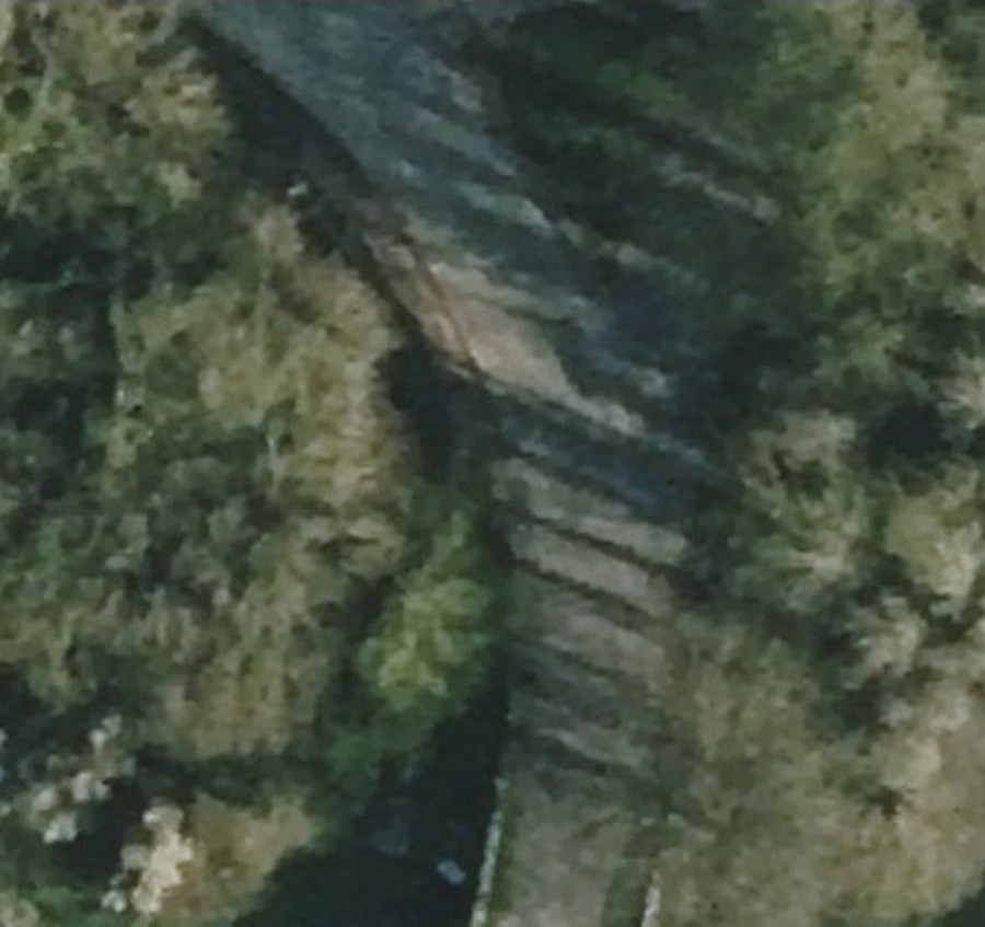 Aerial detail of the road north of Killardry Bridge, with lighter ground beside the road and vegetation on either side.